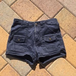 High-waisted navy blue shorts.